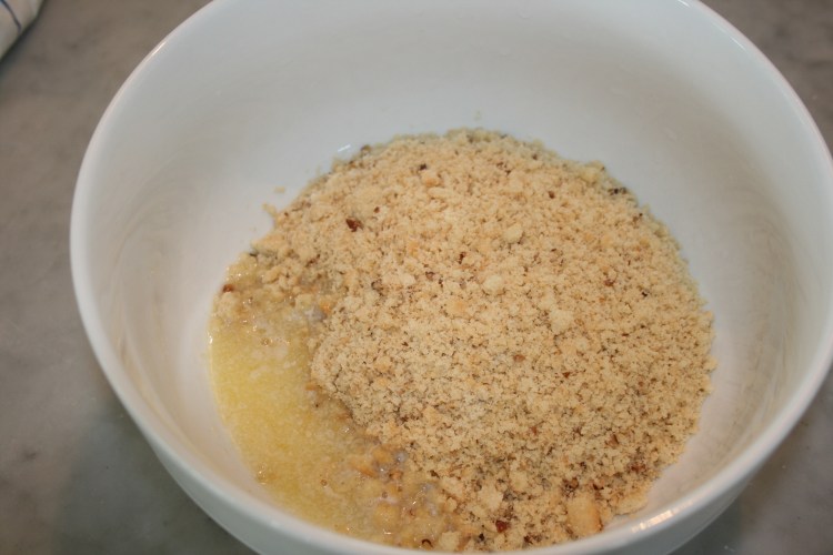 Add cookie crumbs to melted butter.